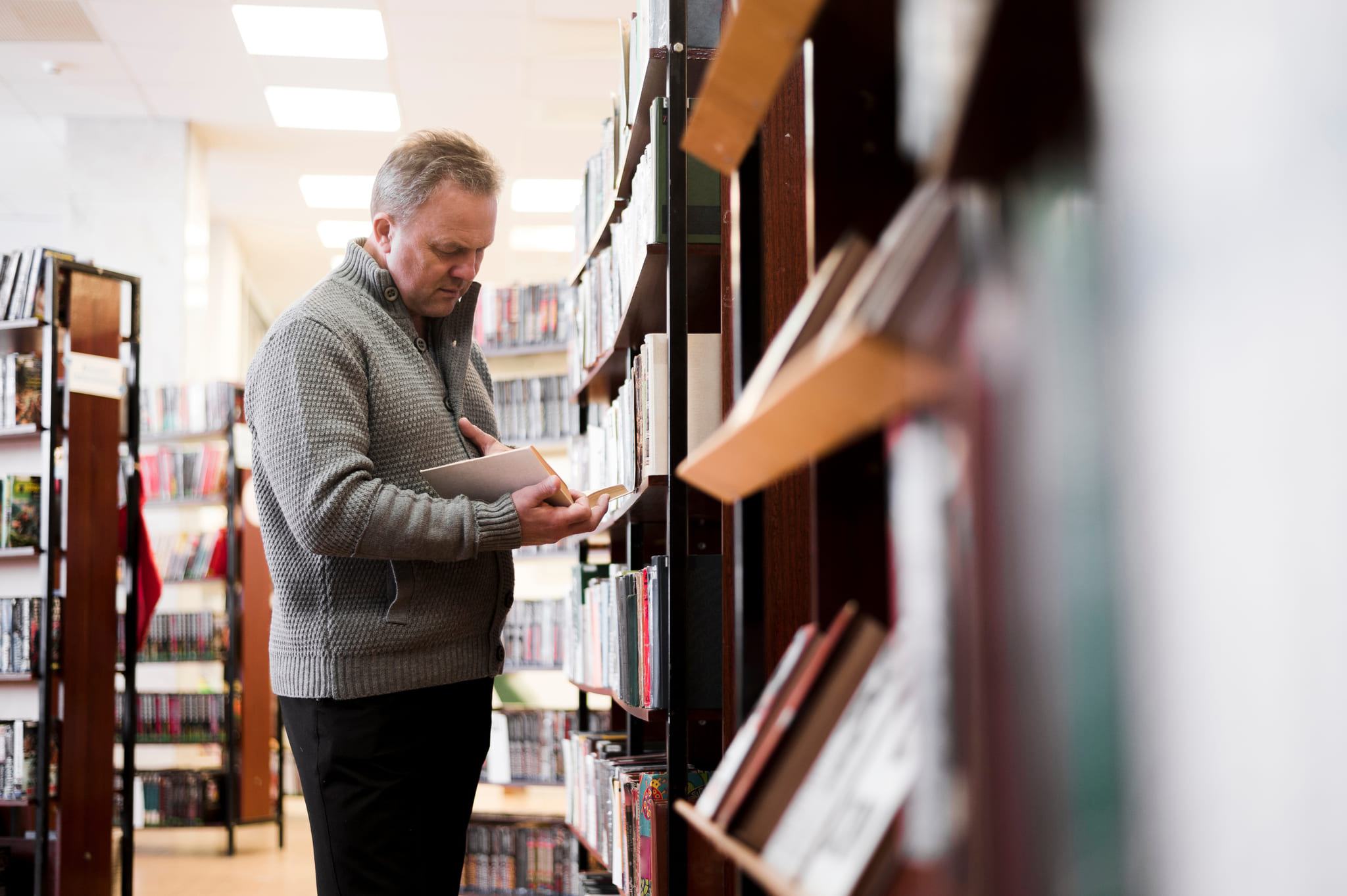Bookseller reviewing a book in store